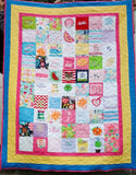 Quilt made from baby bibs, onesies, and some of mom's clothing